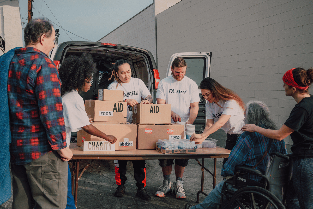 Community group loading donation boxes into van